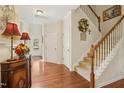 Inviting foyer with hardwood floors, staircase, and tasteful decor creates a warm entrance at 3633 Willow Stone Ln, Wake Forest, NC 27587
