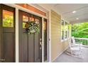 Inviting front porch with rocking chairs and a beautifully decorated front door welcomes you home at 3650 Brooks Bnd, Franklinton, NC 27525