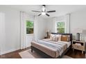 Cozy bedroom with hardwood floors, a ceiling fan, natural light, and neutral decor at 3907 Inwood Dr, Durham, NC 27705