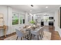 Elegant dining area with glass table, designer chairs, and ample natural light at 3907 Inwood Dr, Durham, NC 27705