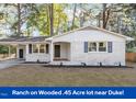 Charming single-story home featuring painted brick, modern fixtures, covered parking, and a well-maintained front yard at 3907 Inwood Dr, Durham, NC 27705