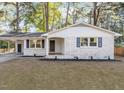 Charming brick home with a covered carport, dark shutters, and a well-maintained lawn at 3907 Inwood Dr, Durham, NC 27705