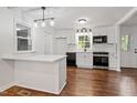Bright kitchen with white cabinets, stainless steel appliances, and stylish lighting at 3907 Inwood Dr, Durham, NC 27705