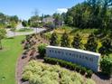 Ryan's Crossing entrance with stone signage, landscaping, and views of the surrounding homes and greenery at 480 Lila Dr, Pittsboro, NC 27312