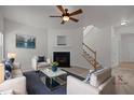 Bright living room featuring neutral colors, a fireplace, and a staircase at 4805 Ayden Mill Rd, Apex, NC 27539