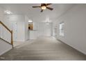 Spacious open-concept layout with staircase, carpet, and access to the kitchen at 4805 Ayden Mill Rd, Apex, NC 27539