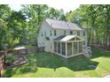 Back exterior with screened-in porch and spacious backyard at 5 Burgess Ct, Hillsborough, NC 27278