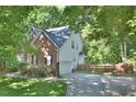 View of the side exterior, showcasing the garage, driveway and neat landscaping at 5 Burgess Ct, Hillsborough, NC 27278