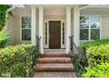 Elegant front door with sidelights and black iron railing, set in a brick entryway at 51 Abernathy Dr, Chapel Hill, NC 27517