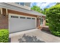 Spacious two-car garage with white doors and brick exterior, offering convenient parking at 51 Abernathy Dr, Chapel Hill, NC 27517