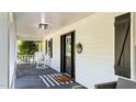 Cozy front porch with rocking chairs and a welcome mat, perfect for relaxing and enjoying the outdoors at 512 Stratford Dr, Zebulon, NC 27597