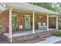 Inviting covered front porch with rocking chairs, perfect for enjoying quiet moments outdoors at 5319 Memory Ln, Durham, NC 27712
