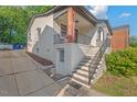 Side view of this home with a private entrance, beautiful brickwork, and lovely landscaping at 623 Massey Ave, Durham, NC 27701