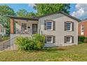 Inviting exterior view showcasing a painted white brick home and quaint front porch seating area at 623 Massey Ave, Durham, NC 27701