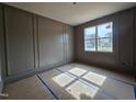 Bedroom with custom dark-gray paneled walls and large window providing natural light at 629 Conover Rd, Durham, NC 27703