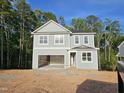 Two-story home with gray siding, white trim, and an attached two-car garage at 629 Conover Rd, Durham, NC 27703