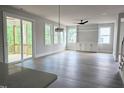 Bright and airy living room with hardwood floors, lots of natural light, and a sliding glass door to the deck at 629 Conover Rd, Durham, NC 27703