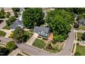 Aerial view of a home with mature trees, a well-manicured lawn, and a cozy front porch at 6509 Virgilia Ct, Raleigh, NC 27616