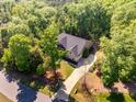 An elevated shot shows the house, driveway, and lush foliage surrounding the property at 67 Crimson Way, Pittsboro, NC 27312