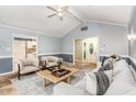 Inviting living room boasts a vaulted ceiling, ceiling fan and neutral color palette at 6820 Chamonix Pl, Raleigh, NC 27613