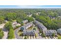 Aerial view showcasing a community of townhomes surrounded by lush greenery and mature trees in a tranquil setting at 710 Samuel Cary Dr, Cary, NC 27511