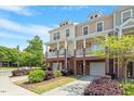 Beautiful townhome complex with welcoming porches, attached garages, and lush landscaping at 710 Samuel Cary Dr, Cary, NC 27511