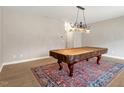 Bright game room featuring an elegant pool table on a large rug with decorative lighting at 710 Samuel Cary Dr, Cary, NC 27511