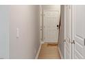 Clean hallway features neutral walls, and light colored flooring leading to doorways at 710 Samuel Cary Dr, Cary, NC 27511