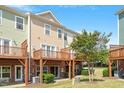 Townhome back exterior featuring private wooden decks perfect for outdoor relaxation and entertainment at 710 Samuel Cary Dr, Cary, NC 27511