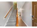 Welcoming foyer featuring a staircase with wood railing and carpeted steps, complemented by neutral wall color at 710 Samuel Cary Dr, Cary, NC 27511