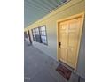Apartment exterior with yellow door, black windows, and 'Shoes Off Homie' door mat at 807 W Trinity Ave # 144, Durham, NC 27701