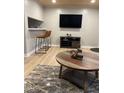 Entertainment area with mounted TV, modern furniture, and rustic accent pieces at 807 W Trinity Ave # 144, Durham, NC 27701