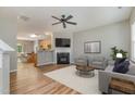 Open-concept living room featuring a fireplace and seamless flow into the kitchen at 809 Amarillo Rose Ln, Durham, NC 27712