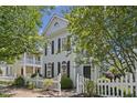 A light blue two-story home stands out with its classic design and trimmed landscaping at 815 Carpenter Town Ln, Cary, NC 27519