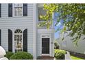 Close-up of the front door of the home, showing the address, sidelight window and porch at 815 Carpenter Town Ln, Cary, NC 27519