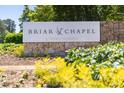 Briar Chapel community sign amidst lush greenery by Newland communities at 92 Cardinal Ridge Rd, Chapel Hill, NC 27516
