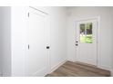 Bright entryway with a door with glass and side door; features durable vinyl plank flooring at Lot 3260 Yorkshire Cir, Sanford, NC 27332