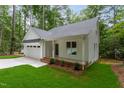 Inviting home boasts a spacious front porch, attached garage, and professionally landscaped yard at Lot 3260 Yorkshire Cir, Sanford, NC 27332