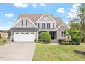 Beautiful two-story home with landscaped front yard, stone accents, and attached garage at 10 Princeton Manor Dr, Youngsville, NC 27596