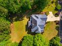 A top-down aerial view shows an expansive lawn and a home's blue roof at 100 Panoramic Ct, Cary, NC 27519