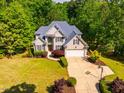 An eye-level aerial view shows the landscaping and traditional architecture at 100 Panoramic Ct, Cary, NC 27519