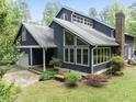 This two-story home has a well-manicured lawn and an attached garage at 1000 Phils Creek Rd, Chapel Hill, NC 27516