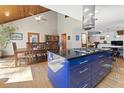 Spacious kitchen with a large island, adjacent to a formal dining area, and a wood-paneled ceiling at 1000 Phils Creek Rd, Chapel Hill, NC 27516