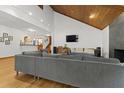 Comfortable living room featuring a modern sofa, hardwood floors, and an adjoining room at 1000 Phils Creek Rd, Chapel Hill, NC 27516