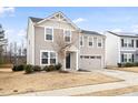 Inviting two-story house featuring a two-car garage and classic architectural details at 1012 Old Evergreen Dr, Durham, NC 27704