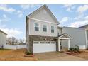 Charming two-story home with stone accents and a two-car garage at 1016 Matterhorn Dr, Fuquay Varina, NC 27526
