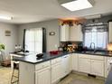 Spacious kitchen featuring a breakfast bar, ample storage, and a bright, inviting atmosphere at 107 N Pearl St, Princeton, NC 27569