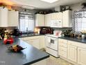 Well-maintained kitchen with white cabinets, plenty of countertop space, and updated appliances at 107 N Pearl St, Princeton, NC 27569