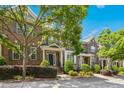 Charming brick townhouse with manicured landscaping, covered entrance, and a beautifully blue summer sky at 1103 Weston Green Loop, Cary, NC 27513