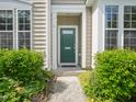 Inviting home entrance featuring a green front door and well-manicured landscaping at 111 Grey Elm Trl, Durham, NC 27713